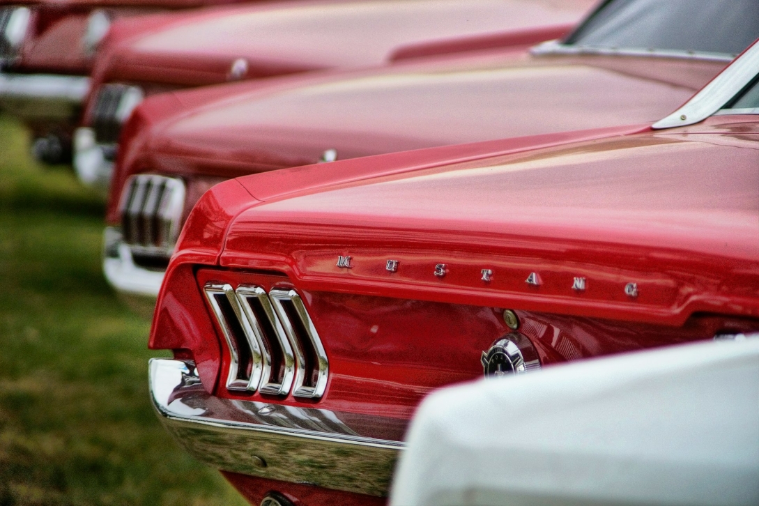 parked red ford mustang cars